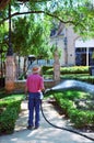 Gardener watering the gardens of the city, Seville, Spain