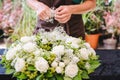 Gardener woman creating grave decoration