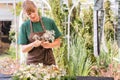 Gardener woman creating grave decoration