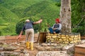 Gardeners are tending the tea valley. Garden workers taking care of plants