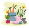 Gardening bucket with carrot boots shovel rake vegetables and flowers
