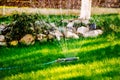 Gardening close up automatic lawn watering system with pop-up sprinklers