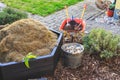 Gardening - composter, bucket with stones and wheelbarrow with soil Royalty Free Stock Photo