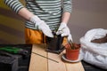 Gardening concept: girl planting succulent into flower pot using universal cactus soil.