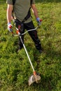 Gardening concept. Man cutting the lawn with electric grass trimmer Royalty Free Stock Photo