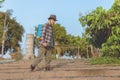 Gardening concept a young male farmer spraying a chemical pesticide for preventing the crops from the pests