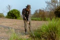 Gardening concept a young male gardener taking care of a vegetable by shoveling the soil around the plant