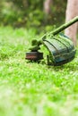 Gardening. Cutting the lawn with cordless grass trimmer, edger