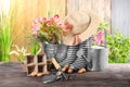 Gardening equipment with gumboots on wooden table