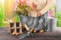 Gardening equipment with gumboots on wooden table