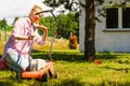 Woman being mowing lawn with lawnmower Royalty Free Stock Photo