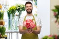 Smiling male seller with bunch of peony flowers