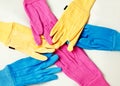 Three pairs of coloured gardening gloves.