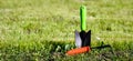 Gardening hand tools in the garden on the grass. Gardening season