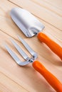 Gardening hand tools - trowel and fork on wooden boards