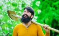 Gardening. Happy man in spring garden. Gardener work. Bearded male planting with shovel. Eco-farm.