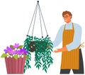 Horticulturist, grower takes care of plants in flowerpots. Man gardener working with houseplants