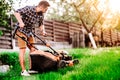 Gardening, industrial gardener starting the lawnmower and cutting grass in garden Royalty Free Stock Photo