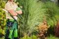 Professional Caucasian Gardener Staying Next to Beautiful Matured Garden