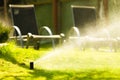 Gardening. Lawn sprinkler spraying water over grass.