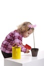 Gardening: little girl planting pink flower