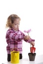 Gardening: little girl planting pink flower