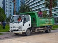 Gardening machine. Truck for loading branches and other garden debris. Gardeners pruned trees