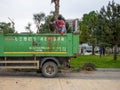 Gardening machine. Truck for loading branches and other garden debris. Gardeners pruned trees