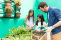 Father teaching his kids about gardening at home Royalty Free Stock Photo