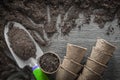 Gardening peat pots soil spade on wooden board