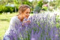 Young woman smelling lavender flowers in garden Royalty Free Stock Photo