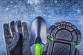 Gardening safety gloves knee pads hand shovel on metallic backgr