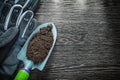 Gardening shovel soil protective gloves on wooden board