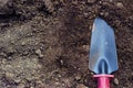 Gardening - small garden trowel on soil Royalty Free Stock Photo