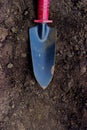 Gardening - small garden trowel on soil Royalty Free Stock Photo