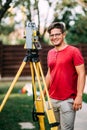 Gardening surveyor working with total station on garden elevation during landscaping Royalty Free Stock Photo