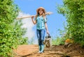 Gardening tips. Spring gardening. Girl child hold shovel watering can. Spring gardening checklist. Little helper Royalty Free Stock Photo