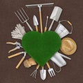 Gardening tool equipment and green grass lawn heart shape, isolated on ground soil background. Banner for online shopping, e- Royalty Free Stock Photo