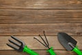 Gardening tools on grey wooden background, top view Royalty Free Stock Photo