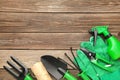 Gardening tools on grey wooden background, top view Royalty Free Stock Photo