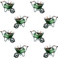 Gardening tools in multiple green wheelbarrows arranged in a repeating pattern Royalty Free Stock Photo