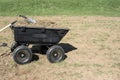 Gardening tools on pile of dirt and grasses in yard cart