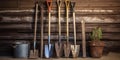 Gardening tools, shovel, rake and pitchfork stand against an old wooden barn wall, concept of Rustic Royalty Free Stock Photo