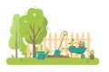 Gardening tools and trees in garden. Royalty Free Stock Photo