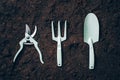 Gardening tools and utensils on soil background. Top view with copy space. Pruner, rake, shovel for garden manteinance. Summer Royalty Free Stock Photo