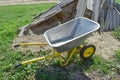 Gardening wheelbarrow for transportation of sand and earth. Two-wheel yellow car Royalty Free Stock Photo