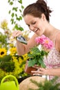 Gardening - woman holding flower pot and shovel