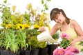 Gardening - woman with watering can pouring water