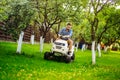 Gardening works with handsome man using lawn mower, Royalty Free Stock Photo