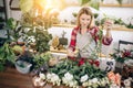 Gardening. Young caucasian florist woman working at garden Royalty Free Stock Photo